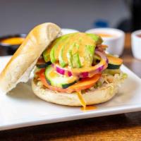 Avocado Veg Out Bagel Sandwich · Lettuce, tomato, cucumber, red onion, avocado, cream cheese finished with a drizzle of honey...