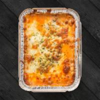 Lasagna · Ground beef, bechamel sauce, mozzarella, ham, and Parmesan cheese.