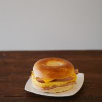 Egg Ham Sausage Cheese Bagel Sandwich · Boiled and baked round bread roll with egg, ham, sausage and cheese.