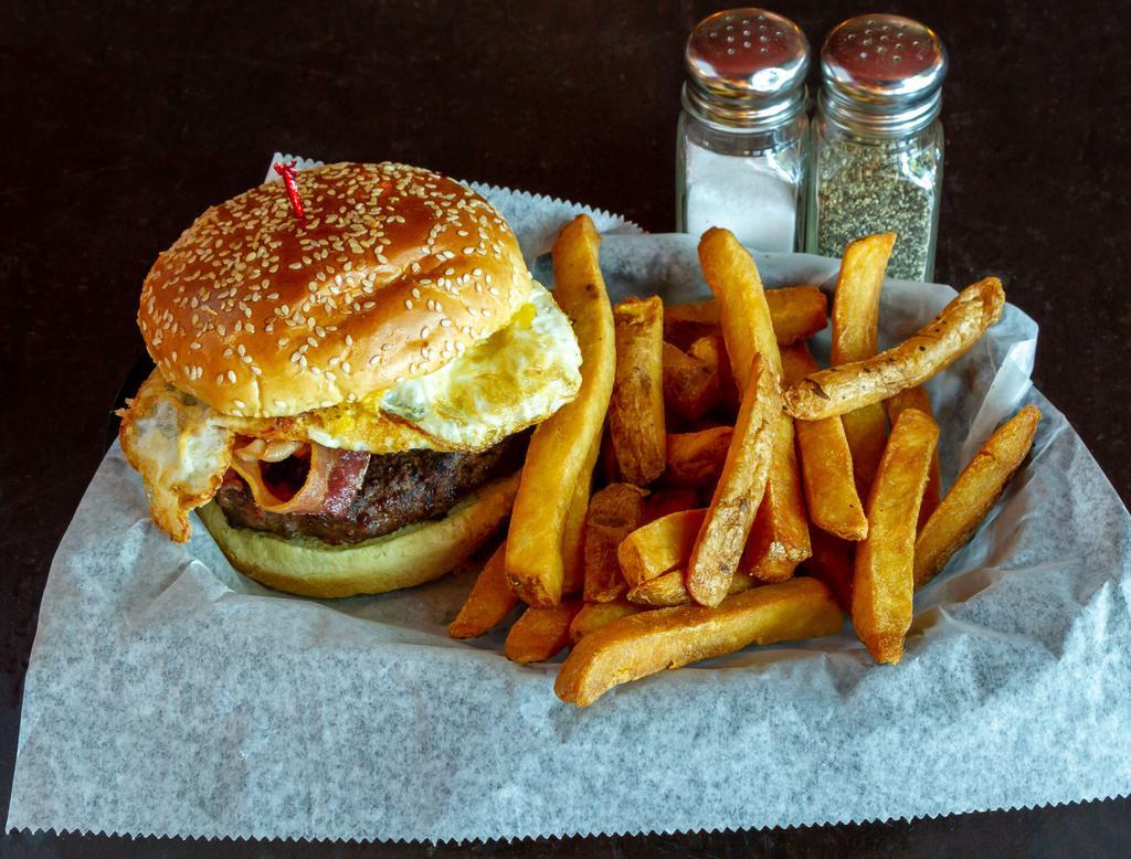 Breakfast Burger · 1/2 lb. Black Angus burger topped with a fried egg, tater tots and bacon. Served with choice of side and a dill pickle.