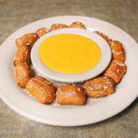 Pretzel Bites · 12 warm bites served with a side of melted cheese for dipping.