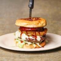 Southwest Cheeseburger · Onion rings and Swiss cheese all topped with Sweet Baby Ray’s  BBQ sauce. Served with lettuc...