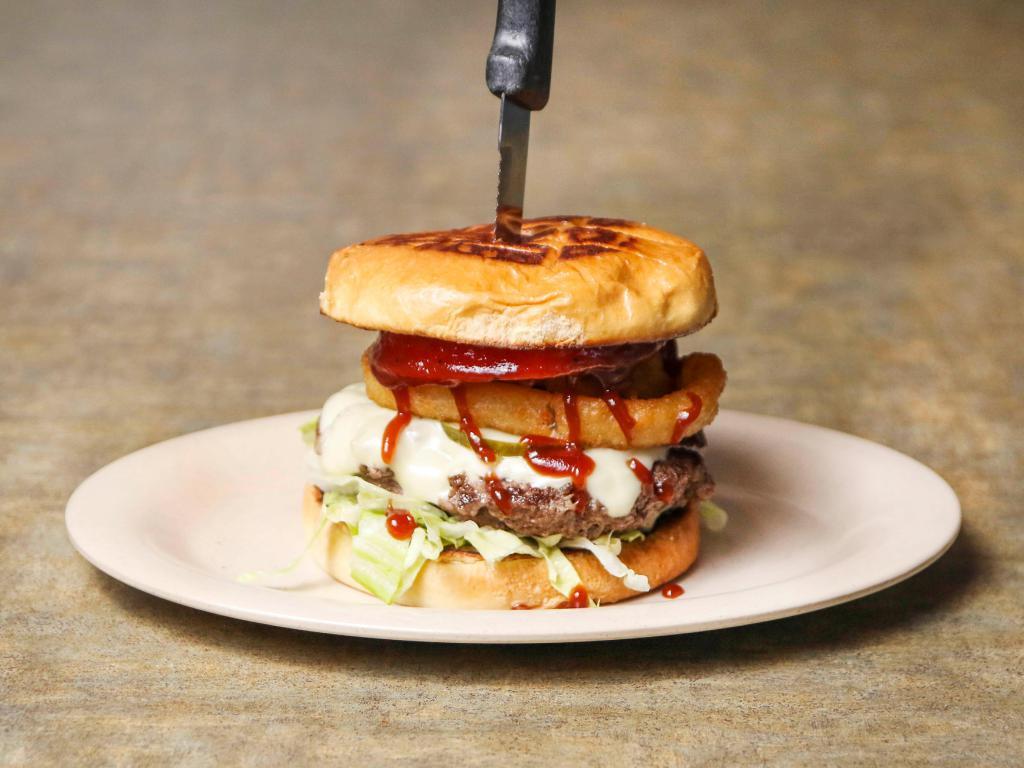 Southwest Burger · 6 oz. all beef patty with onion rings and Swiss cheese all topped with Sweet Baby Ray's BBQ sauce. Served with lettuce, tomato and pickles.