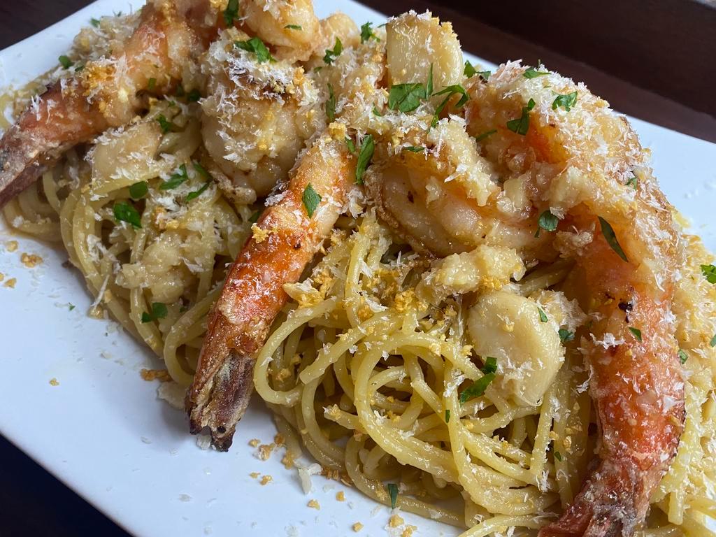 Gnarlic Gnoodles with Calamansi Jumbo Shrimp · Garlic noodles tossed in garlic oyster sauce and garlic butter. Topped with 6 fried garlic calamansi glazed jumbo prawns, Parmesan cheese, fried garlic, whole roasted garlic and more garlic butter. Garlic overload!!