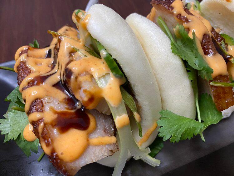 Roasted Tender Pork Belly Baos · Includes scallions, cilantro and sweet pickled cucumber, topped with hoisin and spicy mayo.