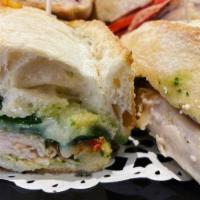 Turkey Pesto Brie Sandwich · Smoked turkey, Brie cheese, roasted red peppers, spinach, and basil pesto mayonnaise on a Fr...