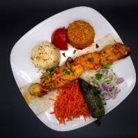 Chicken Shish Kebab · Tender chunks of chicken breast marinated and skewered. Served with grilled veggie, tomatoes...