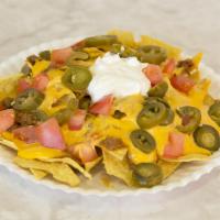 Nachos Supreme · Corn chips, taco beef, sour cream, cheese, tomato and jalapenos with salsa. 