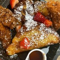 Chicken & French Toast · Thick Cut challah bread paired with 2 crispy tenders garnished with strawberries