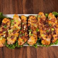 Potato Skins · Jack and cheddar cheese, bacon bits and chives.
