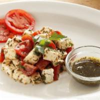 Caprese Salad · Tomatoes, fresh mozzarella, basil and chimichurri dressing.