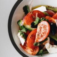 Greek Tomato Salad · Feta cheese, peppers, and olives that are finished with red wine vinegar and extra virgin ol...