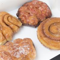 Famous 4-Pack · 1 cinnamon roll, 1 croissant donut square, 1 fritter and 1 filled donut.