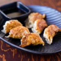 Homemade Gyoza · Juicy Japanese style pork dumplings. Pan fried until golden brown on the bottom. Freshly mad...