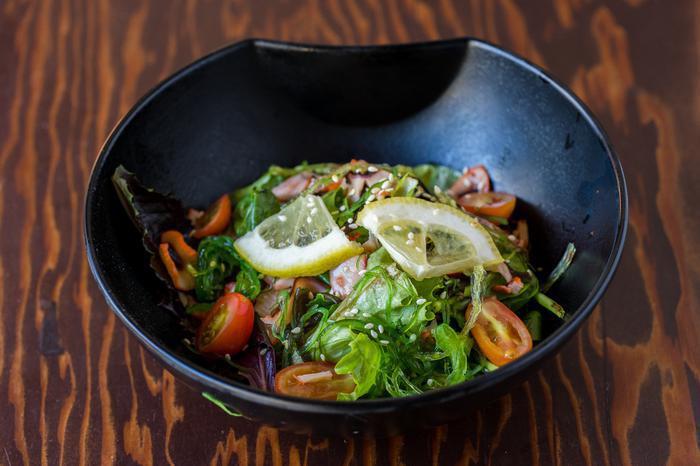 Tako Sunsai Salad · Thinly sliced octopus with wakame, mixed greens and toasted sesame seeds, tossed in light Japanese vinaigrette. A delightful side dish low in calories.
