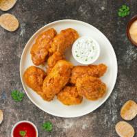 Manic Mango Habanero Wings · Fresh chicken wings breaded, fried until golden brown, and tossed in mango habanero sauce. S...