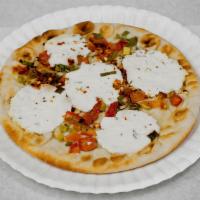 Goat Cheese Manakish · Pita dough pizza topped with Napa Hill goat cheese, green onions, chopped tomatoes, pepper f...