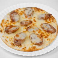 Chicken Apple Sausage Manakish · Pita dough pizza topped with mozzarella cheese and chicken apple sausage.