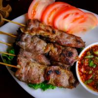 A3. Moo Ping · 6 pieces. Juicy skewered marinated pork grilled and served with homemade sauce. 