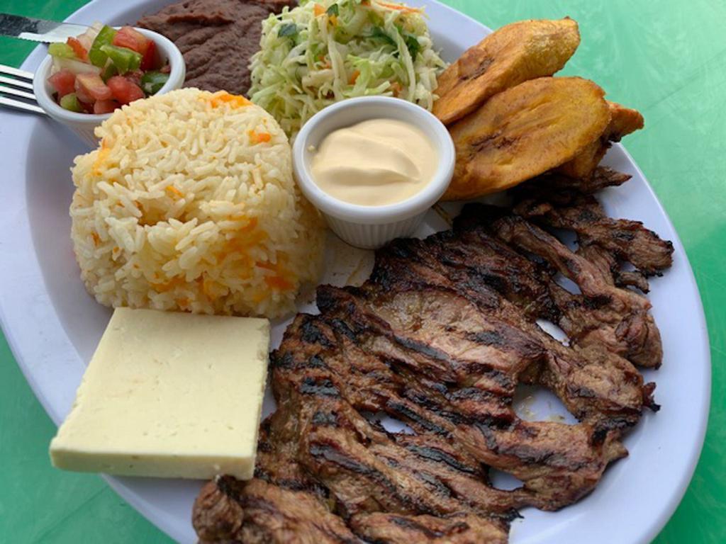 Carnitas Tipicas · Grilled steak, rice, beans, fried cheese, plantains, cream, and cabbage. Carne asada,arroz, frijoles, queso frito, maduros, crema, y repollo