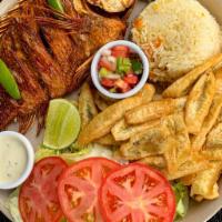 Fried Fish/Pescado Frito · Fried fish with rice, crispy green plantains, and salad. Pescado frito con arroz, tajadas y ...
