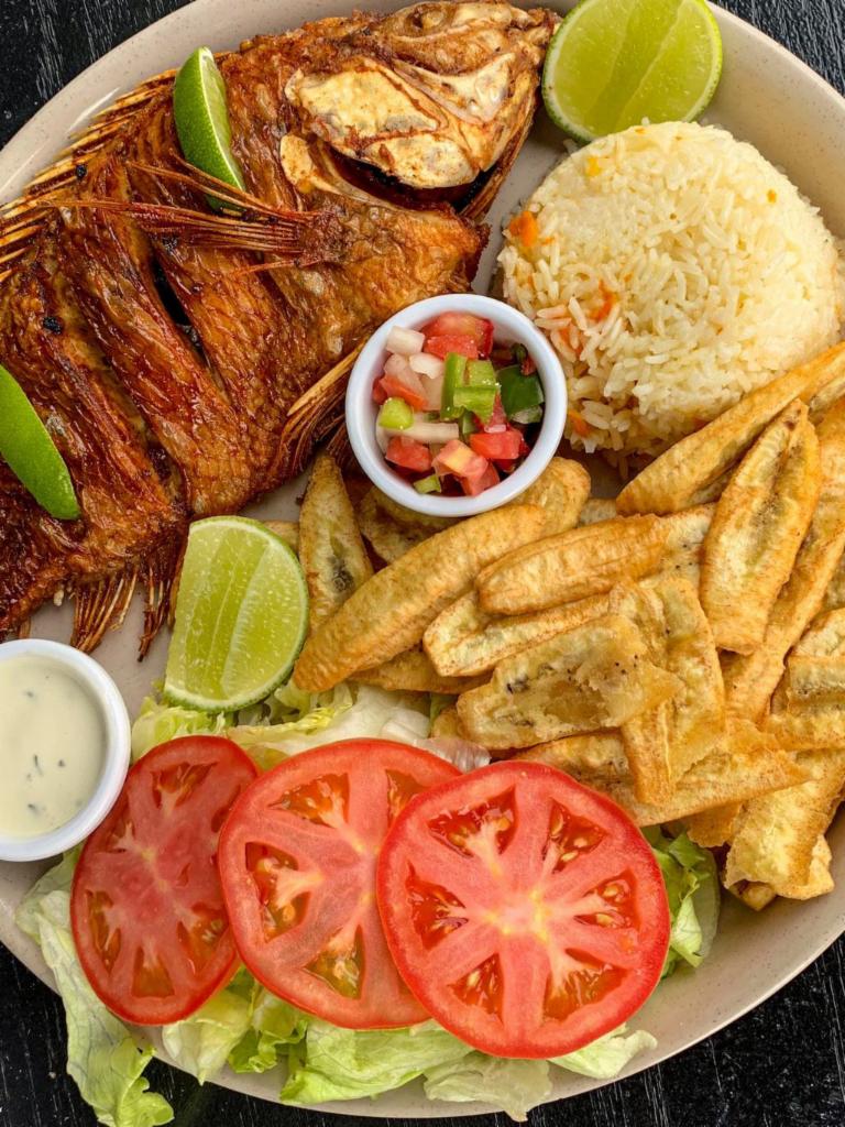 Fried Fish/Pescado Frito · Fried fish with rice, crispy green plantains, and salad. Pescado frito con arroz, tajadas y ensalada