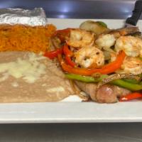Steak Veracruz · T-bone steak and shrimp topped with grilled onions, bell peppers, and tomatoes. Served with ...