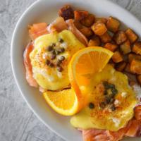 Smoked Salmon Eggs Benedict with Onion & Capers · Smoked salmon on top of our homemade English muffin covered with hollandaise sauce and garni...