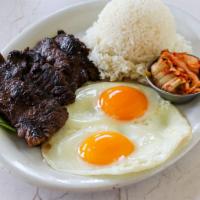 Kalbi & Eggs with Kim Chee · Boneless marinated short ribs paired with 2 eggs cooked any style and comes with a side of s...