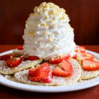 Fresh Strawberry Whipped Cream Pancakes · Five Fluffy Buttermilk Pancakes topped with fresh strawberries whip cream and macadamia nuts