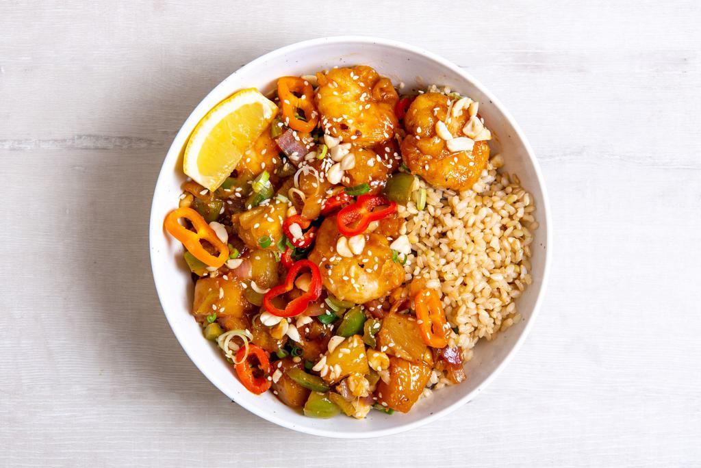 Sweet and Sour Tofu Bowl · Sesame tofu with roasted pineapple, charred peppers, sauteed onions, roasted salt-free peanuts, green onions, sesame seeds, and our house-made sweet and sour sauce.  Served with a lemon wedge, and a base of your choice. (gluten-free)