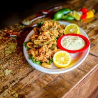 Calamari Don Juan · Tender calamari lightly breaded and fried until golden brown then tossed with jalapeno peppe...