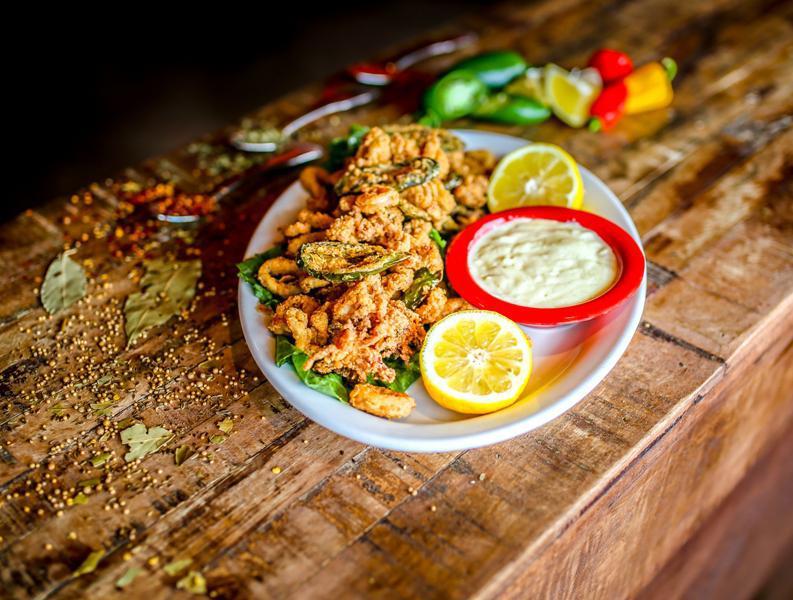 Calamari Don Juan · Tender calamari lightly breaded and fried until golden brown then tossed with jalapeno peppers that have been freshly breaded and fried. Served with a side of creamy, spicy habanero sauce for dipping.