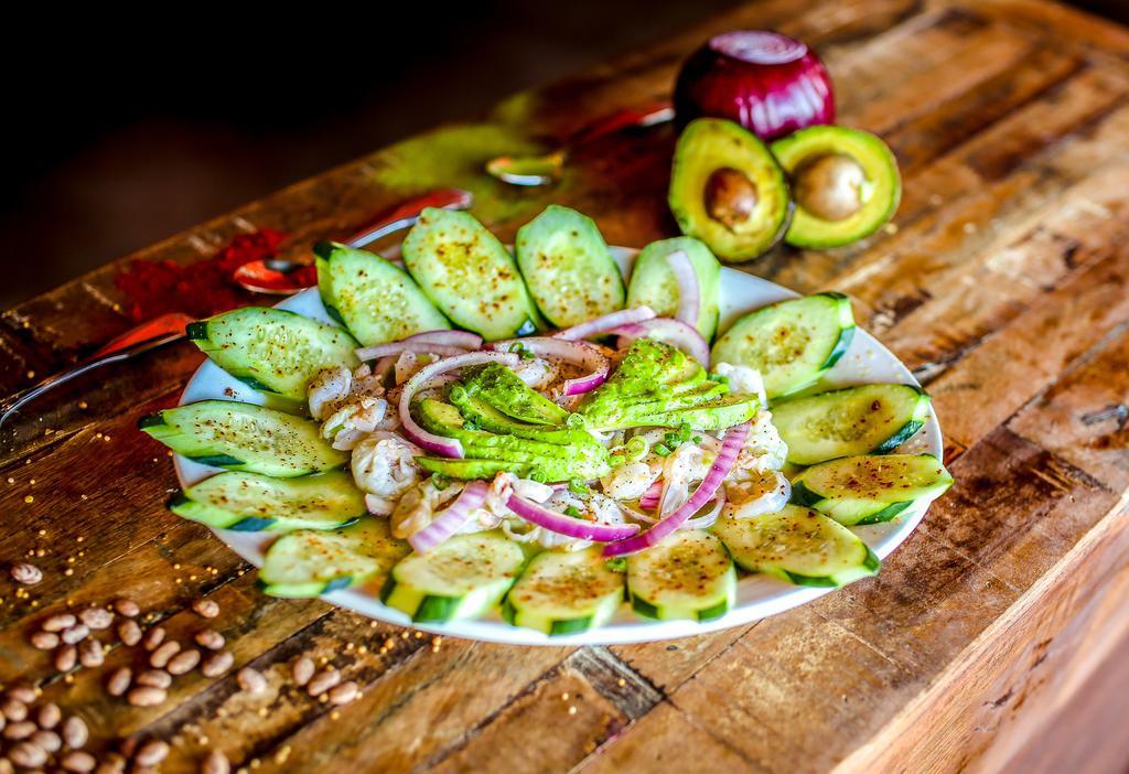 Agua Chiles · Shrimp cooked with fresh lime juice and spicy habanero green sauce, served with cucumbers, avocados and sliced red onions. Served with tortilla chips and saltine crackers. Gluten free.