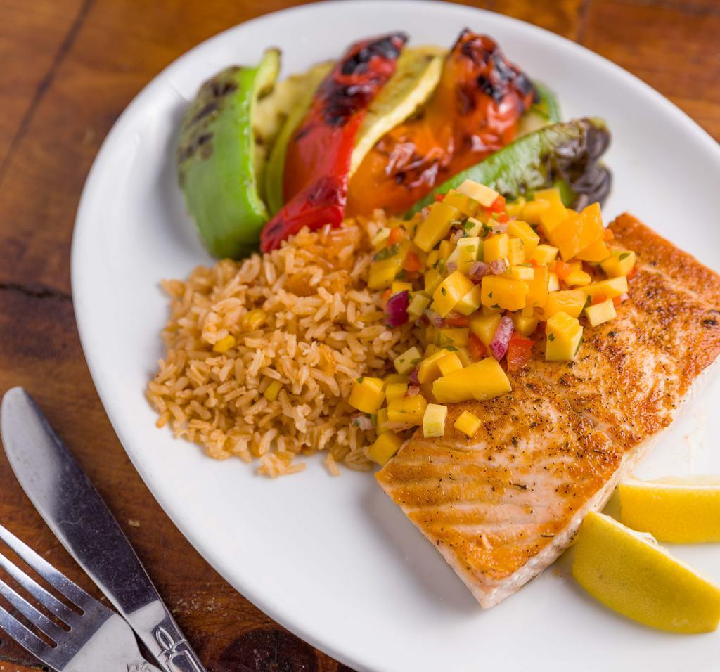 Seared Atllantic Salmon  · Served with grilled vegetables, Mexican rice and tropical salsa. Garnished with lime wedge.