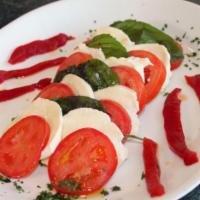 Caprese Salad · Fresh mozzarella, sliced tomatoes, fresh basil and extra virgin olive oi.