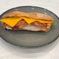 Cali Club Sandwich · Turkey, bacon, cheddar cheese, Greek yogurt, mayo, lettuce, tomato, mustard.