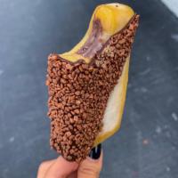 Passion fruit filled with Brigadeiro Ice Pop · Our tart passion fruit sorbet filled with our homemade Brigadeiro and covered with dark choc...