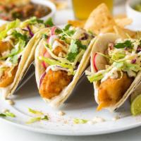 Crispy fish tacos  · Corn tortillas, citrus kale slaw, avocado, chipotle aioli