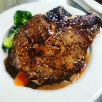 Rib eye steak · Prime rib eye steak 14.oz served with mashed potatoes, garden vegetables, black peppercorn s...