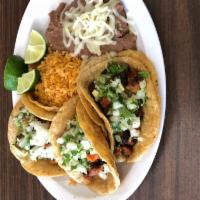 Taco Trio · 3 tacos con la carne de su preferencia, cilantro y cebolla. Acompanados con arroz mexicano y...