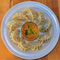 Classic Chicken Momo · Steamed dumplings. Served with our secret momo sauce.
