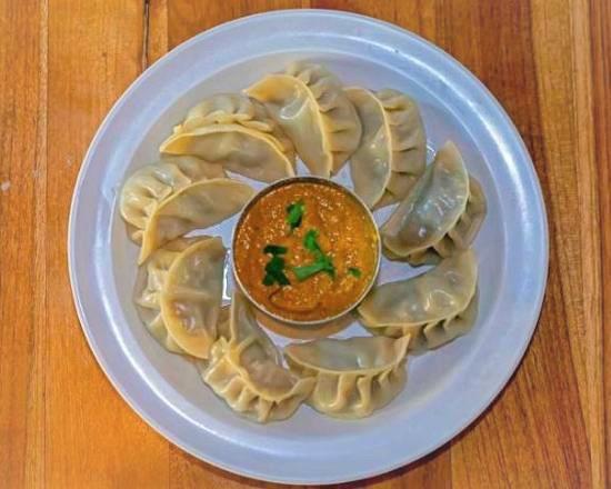 Classic Chicken Momo · Steamed dumplings. Served with our secret momo sauce.