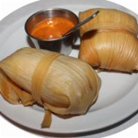 Tandoori Tamales · 2 tamales stuffed with shredded tandoori chicken. Served with a smoked tomato and chili base...