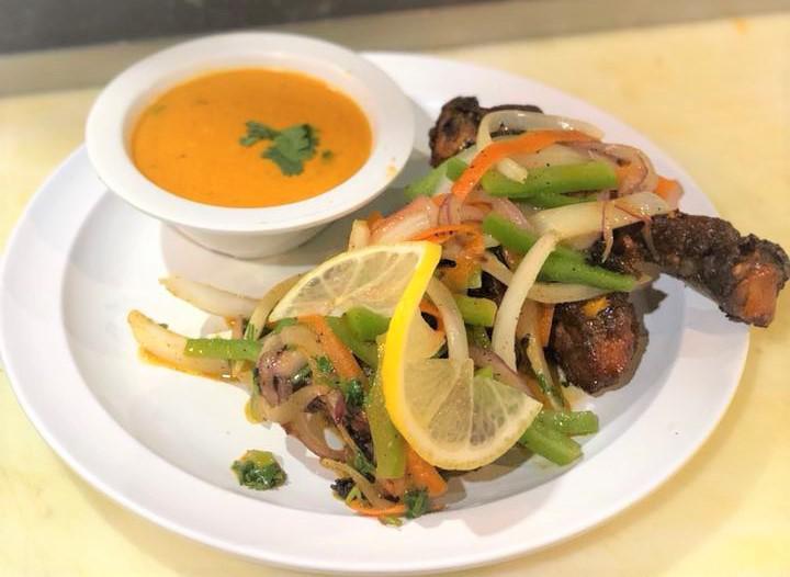 Tandoori Chicken · Bone-in chicken breast and leg marinated in yogurt and freshly ground spices with sautéed onion and peppers.