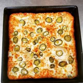 Jalapeno Cheese Bread · Our classic garlic cheese bread with spicy jalapeno baked in. Served with 2 sides of pizza sauce.
