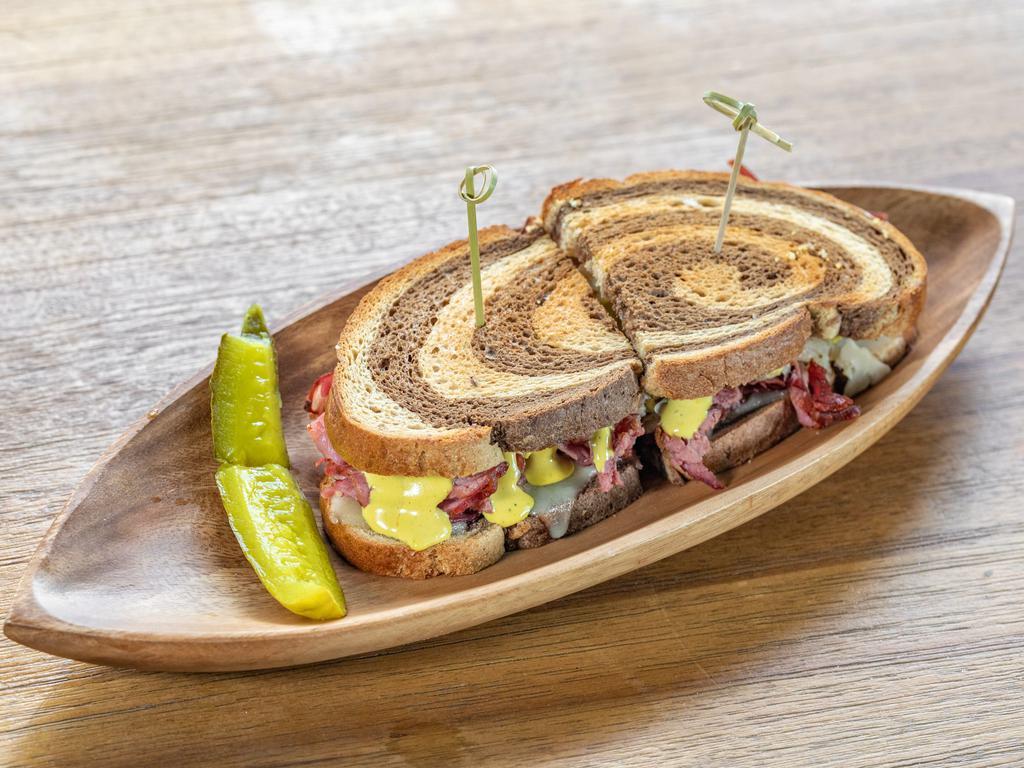 Reuben Sandwich · Sliced pastrami, Swiss cheese, sauerkraut, mustard aioli, marble rye.