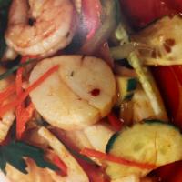 Yum Talay · Shrimps, squid and scallops quickly cooked and tossed with fresh chilli pepper, onion cilant...