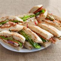 Pesto Chicken Sandwich · White ciabatta bread, chicken breast, romaine lettuce, tomatoes, pesto sauce, and Parmesan c...