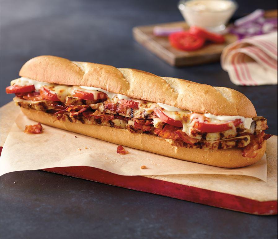 Chicken Club Sub · Chicken breast strips, bacon, tomatoes, mayo and our three-cheese blend.